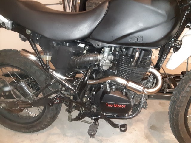 With exhaust pipes fitted, dry fitting new exhaust on TBR7 motorcycle.