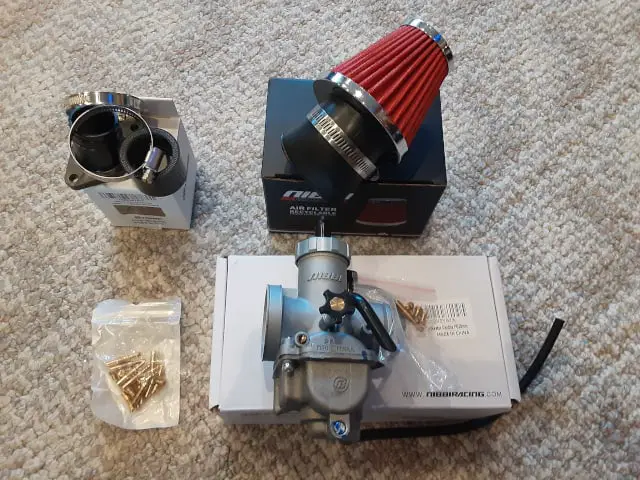 Nibbi carburetor, engine/carburetor connector, air pod filter and carb jets.