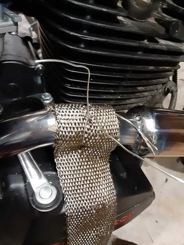 Starting engine exhaust wrap and securing with wire.