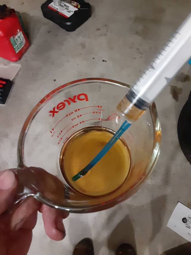 Filling syringe with fresh oil.