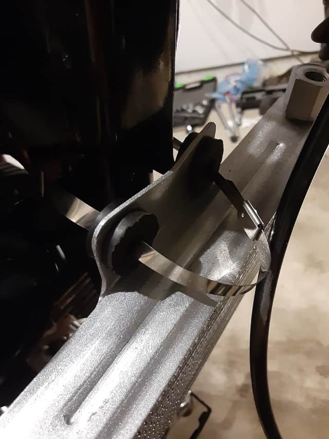 Connecting metal wire tie to motorcycle oil cooler upper mount.