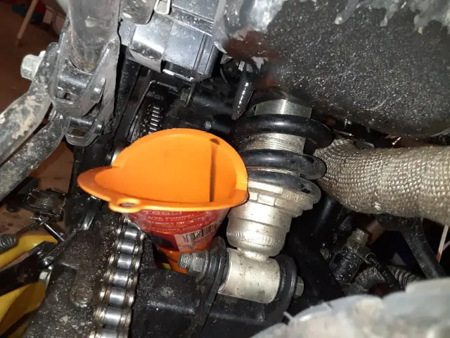 Draining oil from air filter box.