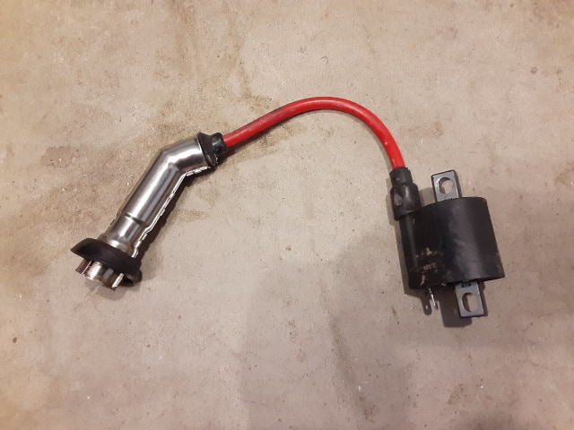 Stock TBR7 ignition coil and spark plug boot.