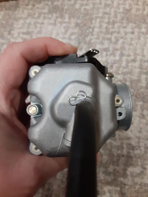 TBR7's stock carburetor has metal blanks over the bowl screws.