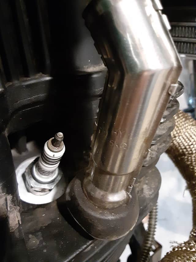 Stock Spark Plug Boot off, and spark plug exposed.