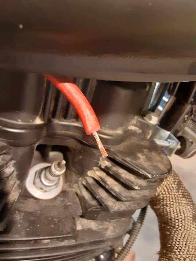 Spark plug wire stripped of insulation.