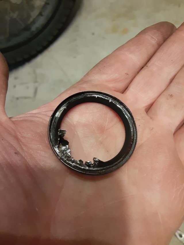 Tore up old motorcycle engine exhaust gasket removing it.