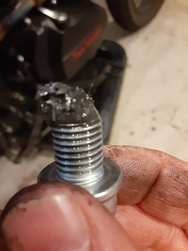 Metal particles on motorcycle engine oil drain plug.
