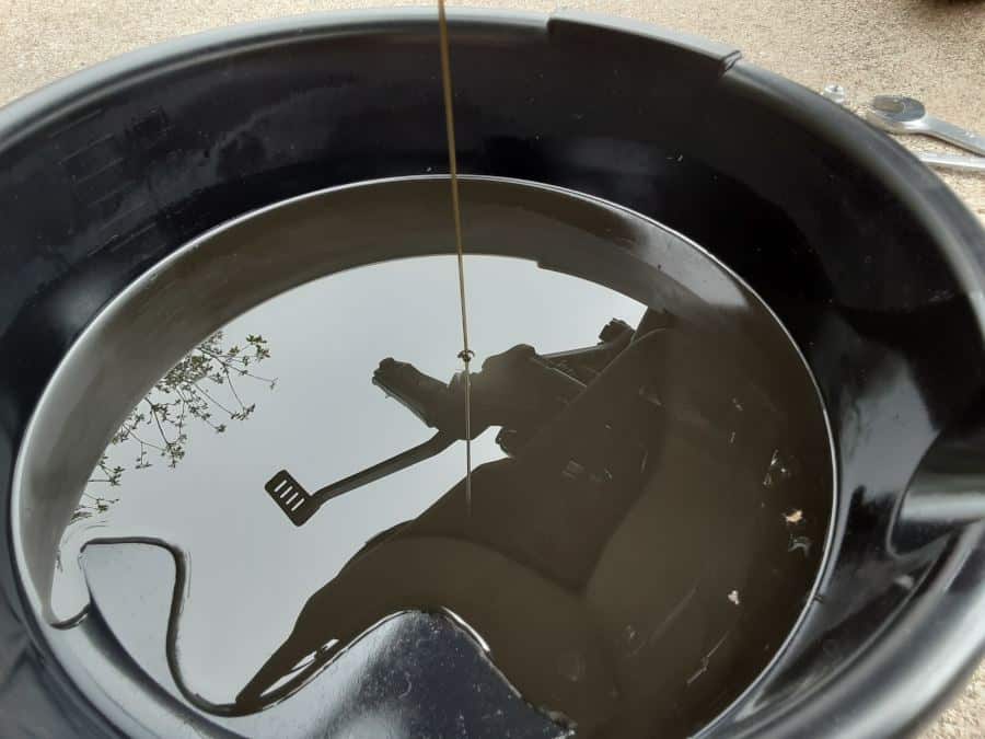 Oil in oil drain pan.
