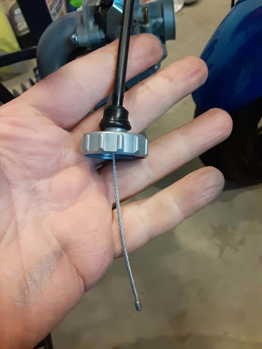 Throttle slide cap on throttle cable.