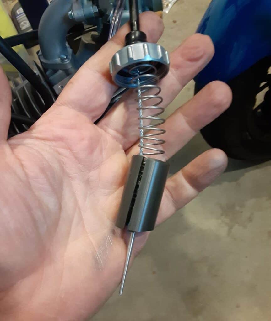 Motorcycle throttle slide and spring.