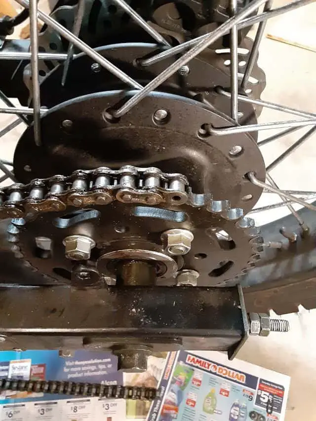 Motorcycle chain end on top of rear sprocket .