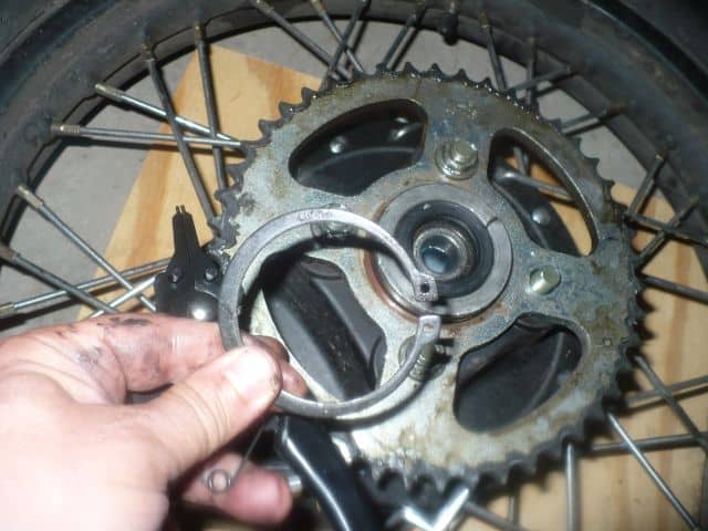 Removed TBR7 motorcycle rear hub snap ring with snap ring pliers.