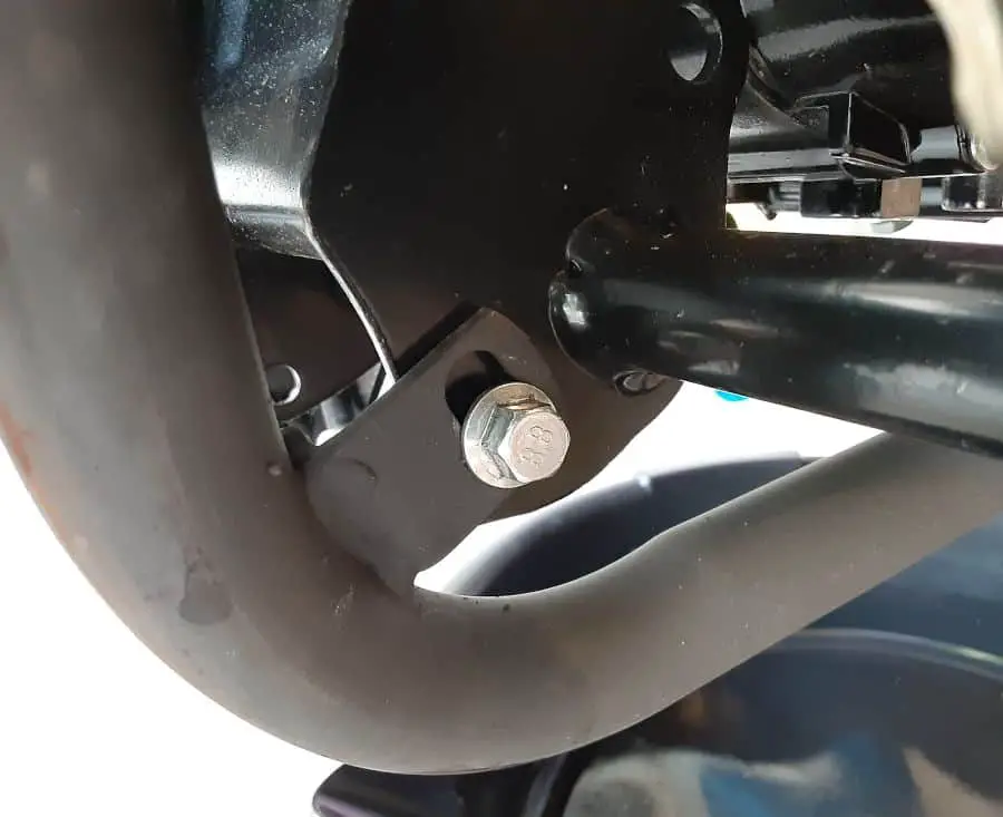 Exhaust hanger bolt, midway under Boom Vader motorcycle.