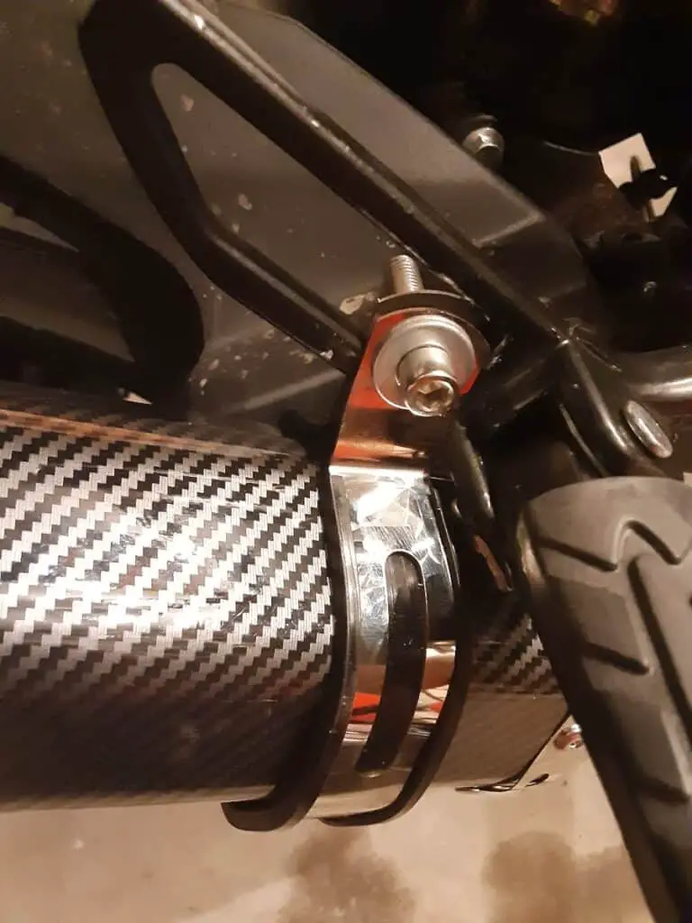 Muffler installed with hanger mounted to rear set - side.
