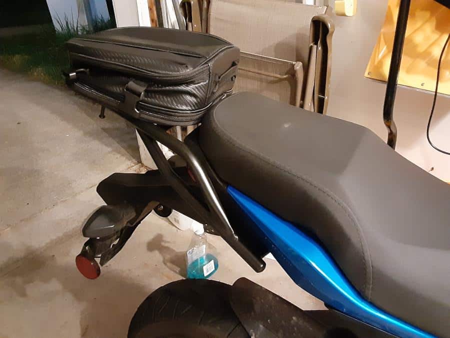New small tail bag sitting on motorcycle luggage rack.