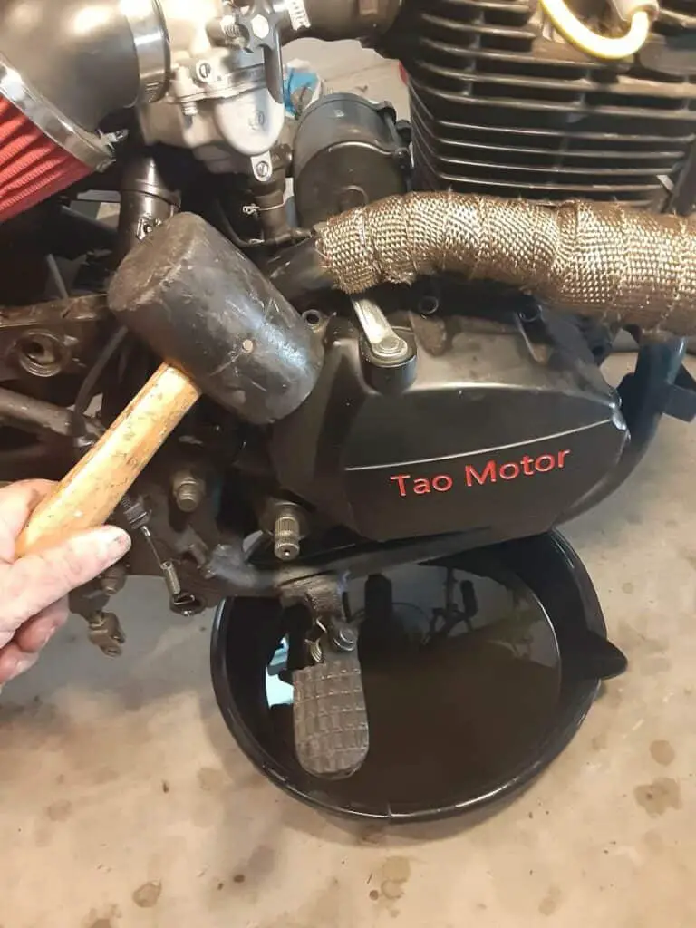 Rubber mallet to loosen motorcycle crankcase cover.