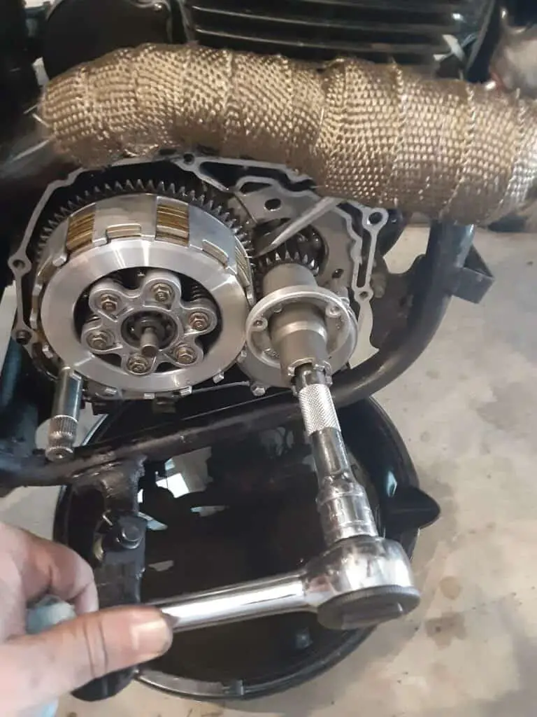 Screw driver will hold gears while unscrewing oil centrifugal filter.