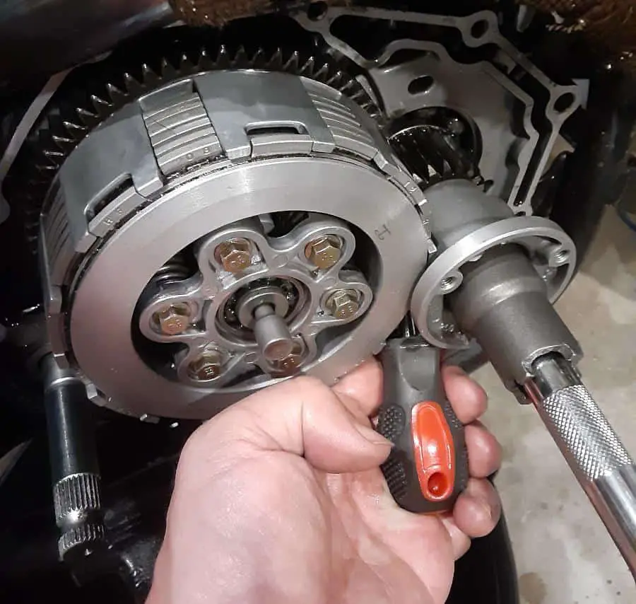 Screwdriver in gears while using wrench.