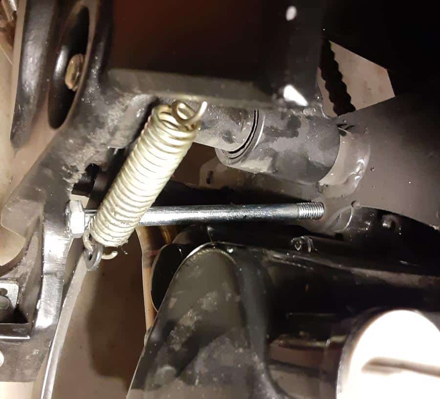Inserting new motor mount bolt from lower end, right side of motorcycle.
