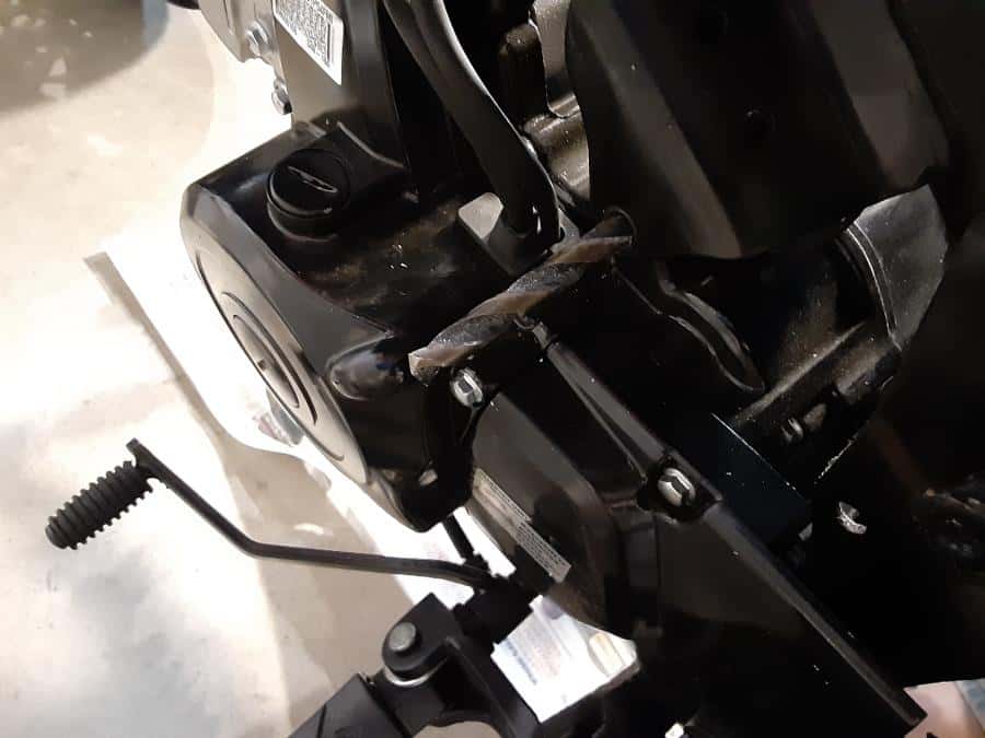 Drill bit tip showing on upper engine mount.