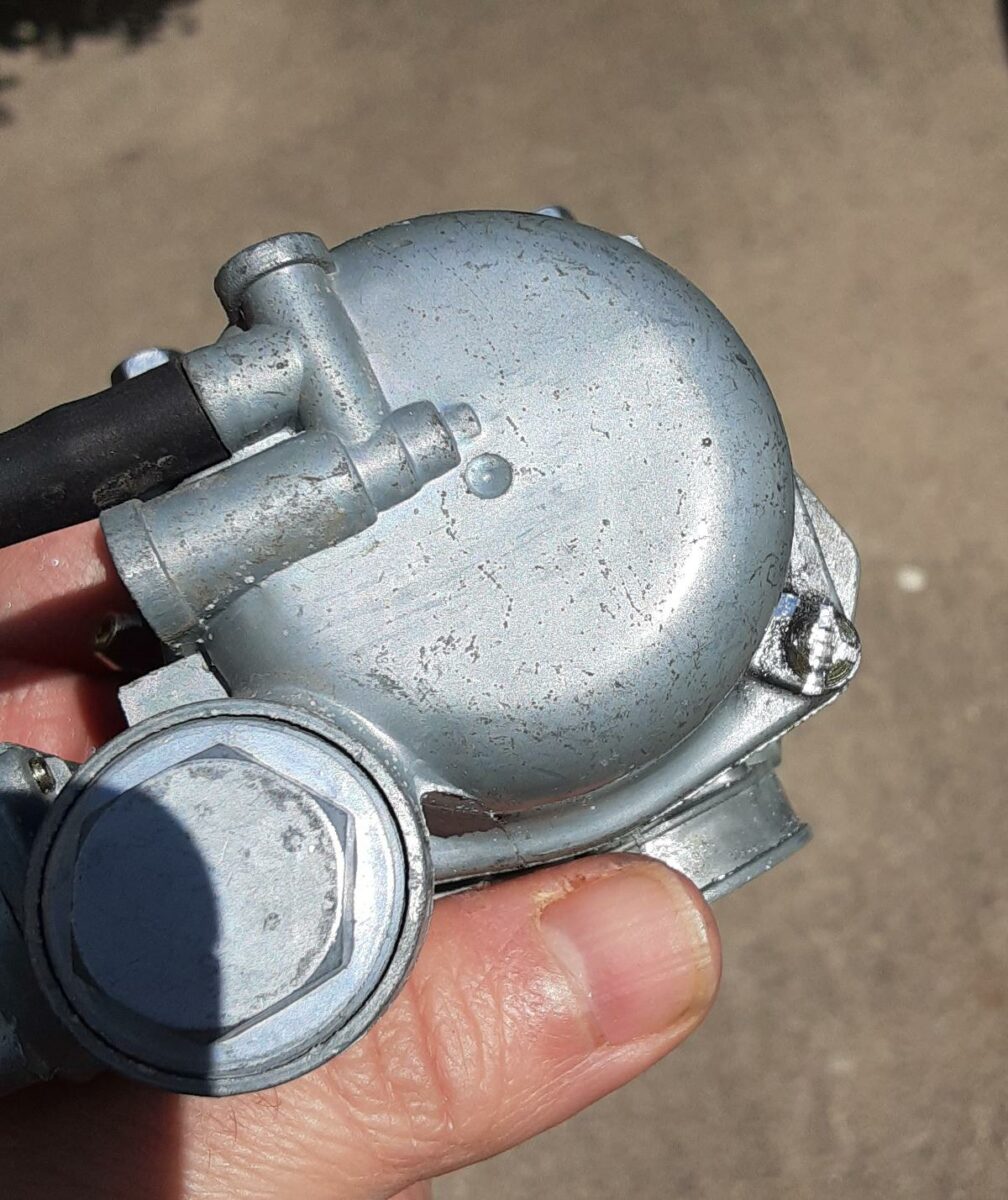 Stock Boom Vader motorcycle carburetor fuel bowl screw with new slot cut.