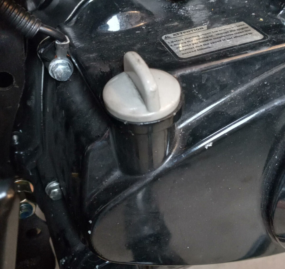 Boom Vader motorcycle engine oil dipstick fully inserted and secured.