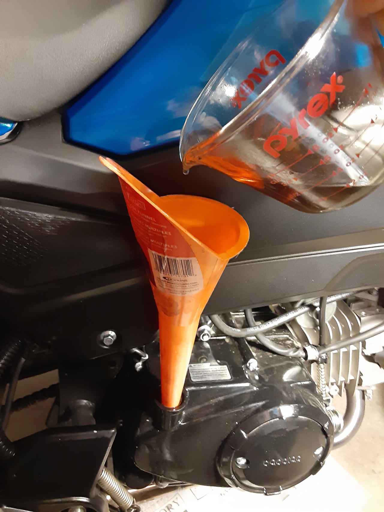 Filling up with motorcycle engine oil.