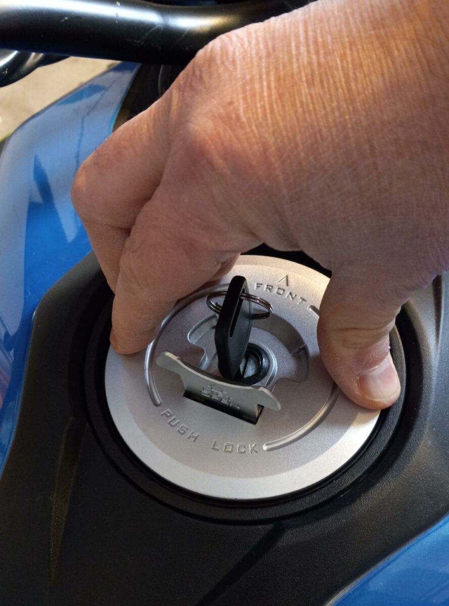 Applying pressure to both left and right side of locking Boom Vader motorcycle gas cap.
